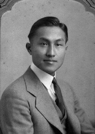 Portrait of Taro Kishi post-university, wearing a gray 3 piece suit