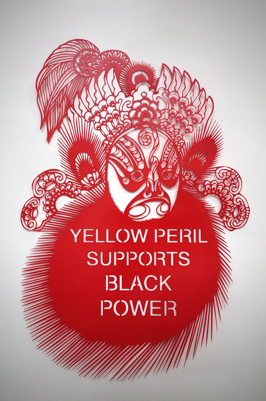 Paper cutting that says "YELLOW PERIL SUPPORTS BLACK POWER"
