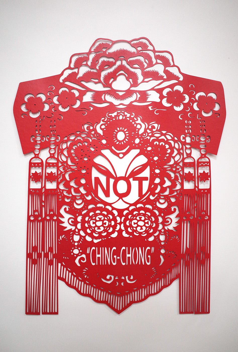 Red paper cutting that reads "NOT CHING-CHONG"