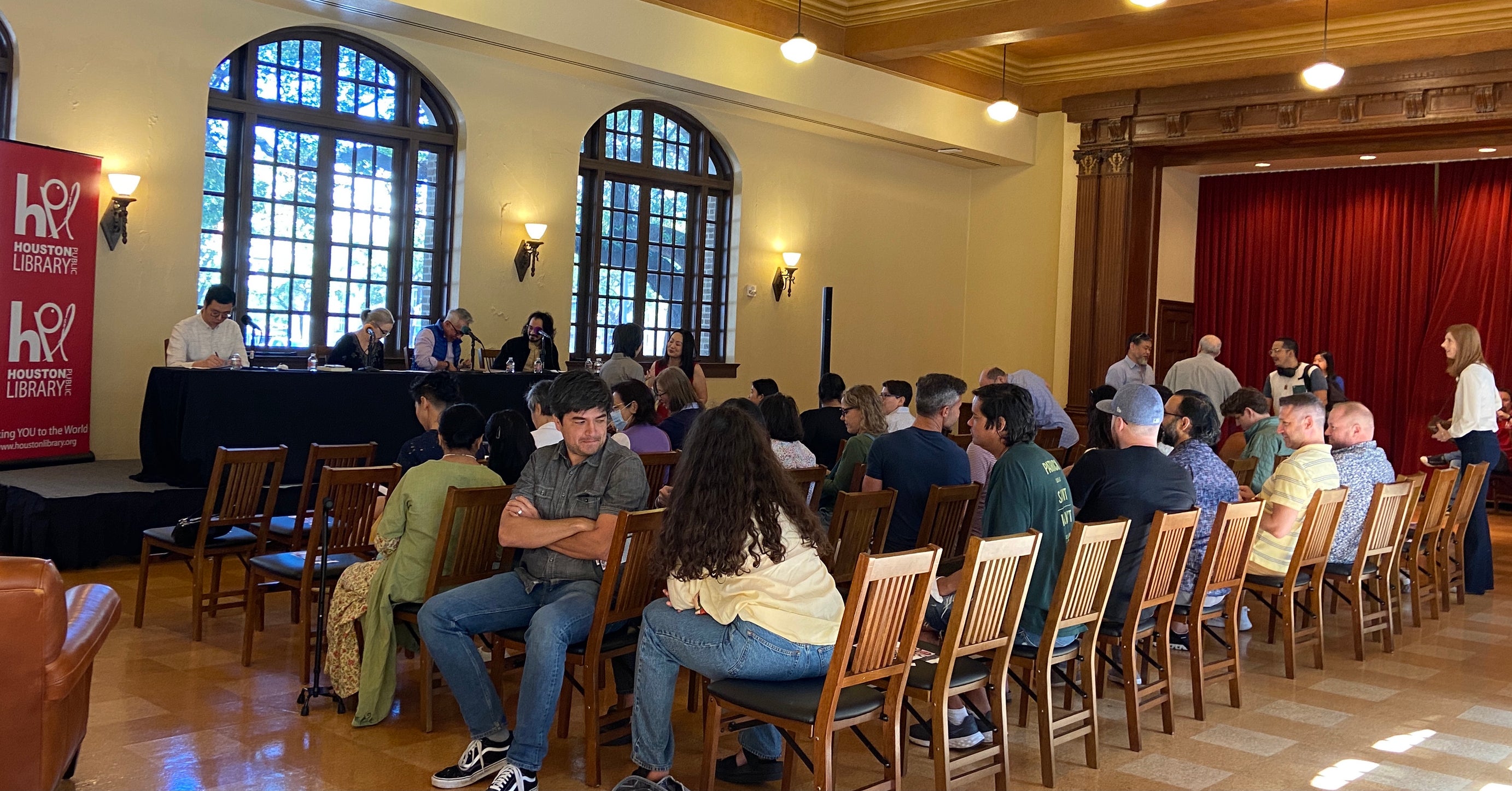 The audience listens to the panel speakers at the front of the room