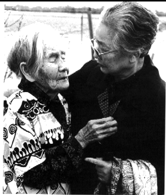 Kichi embracing another older person