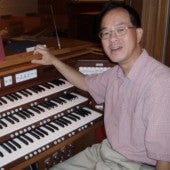 Christopher Lo sitting at an organ